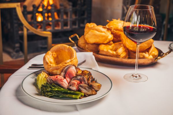 Sunday roast dinner by a cosy fireplace